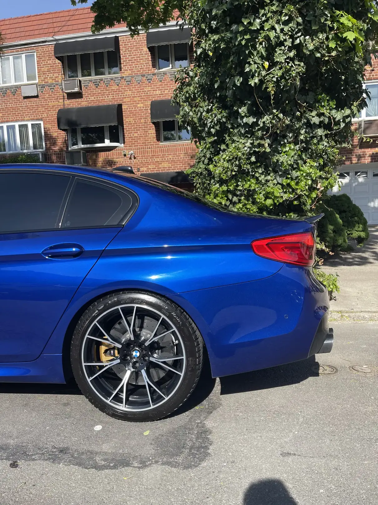 Left quarter panel picture of blue BMW m5 after cleaning